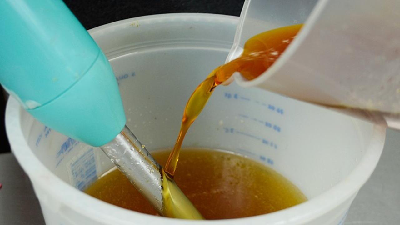 pouring lye into soaping oils