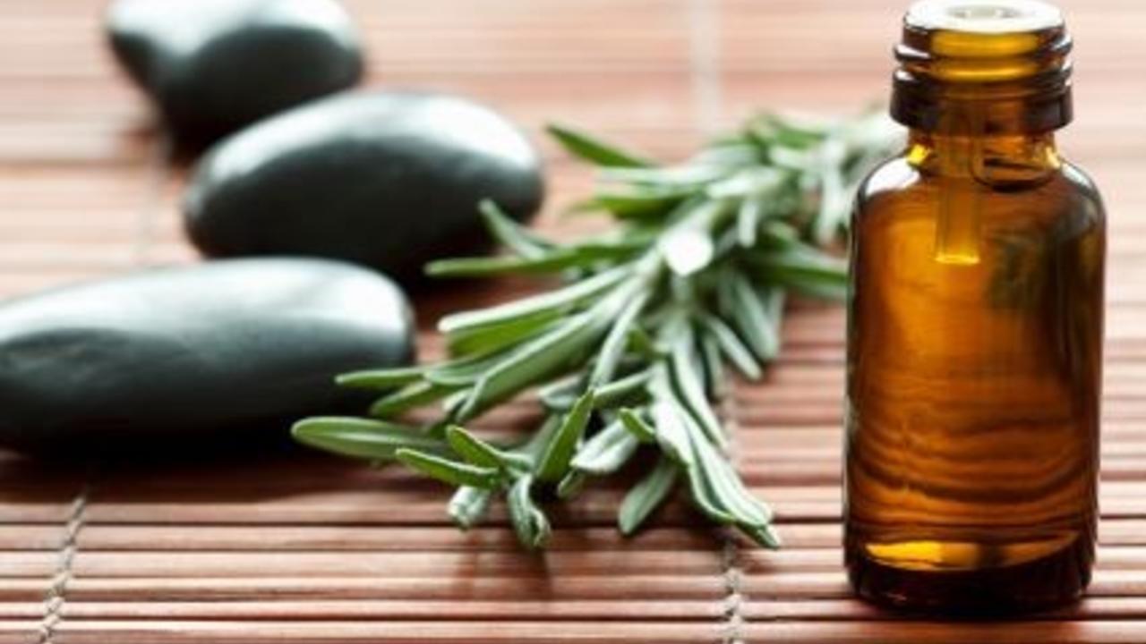 essential oil bottle with rosemary